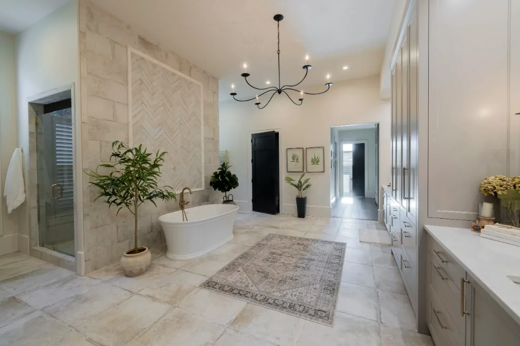 Berkeley Lake — primary bath with freestanding tub and stone tile