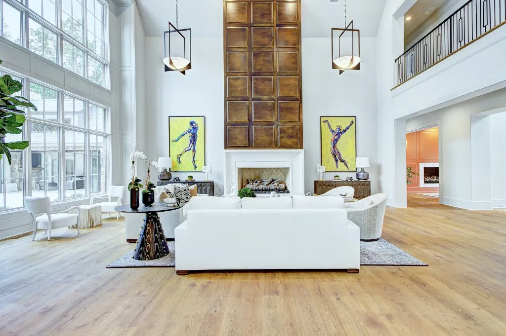 Mtn Lake — two-story living room with stone fireplace and gallery art