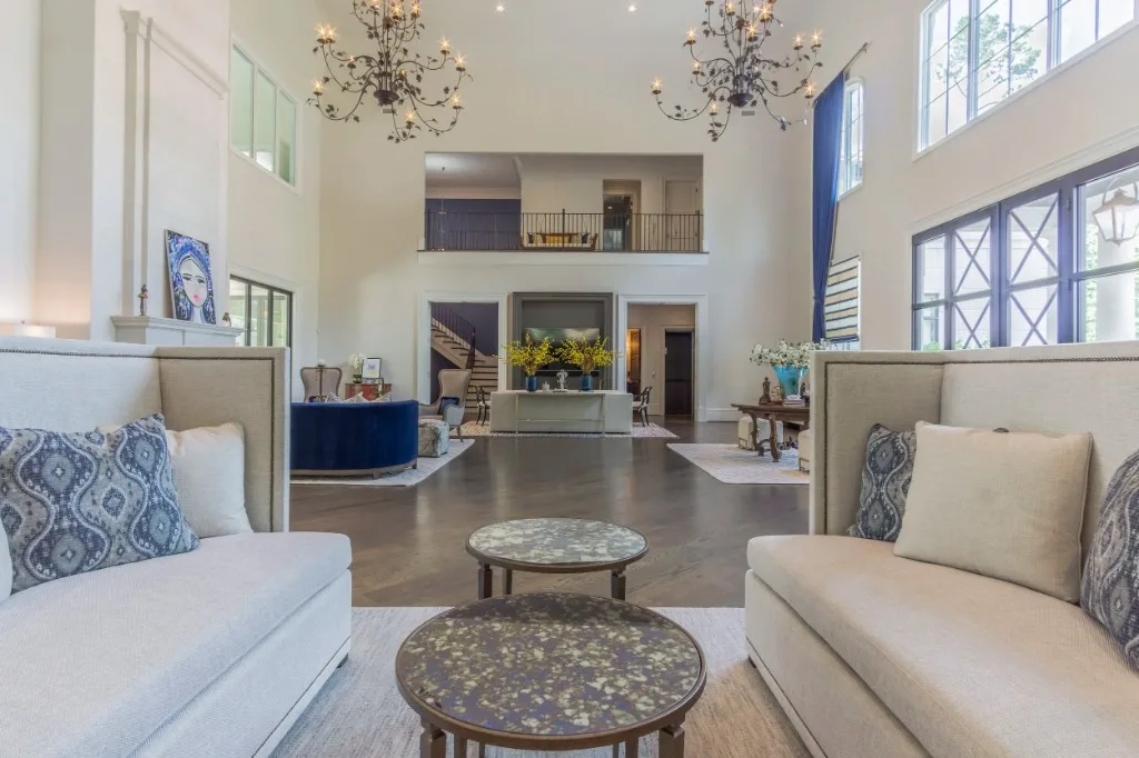 Peachtree Rd — two-story living room with iron chandeliers